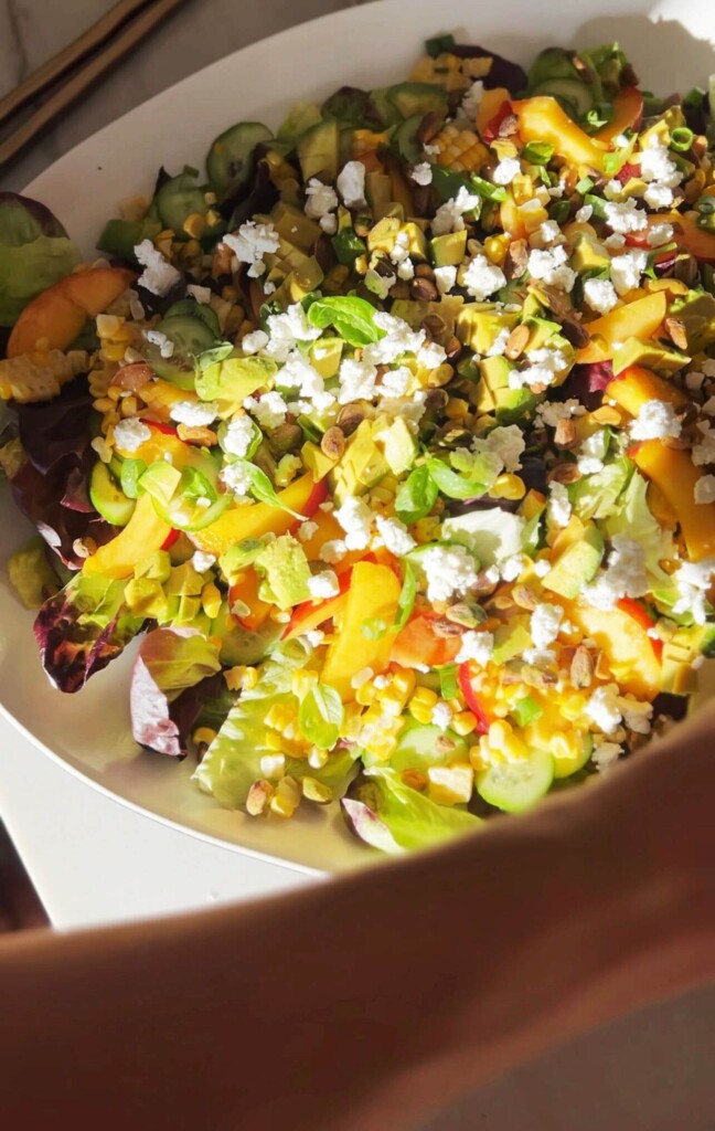 Corn and peach salad in a bowl.