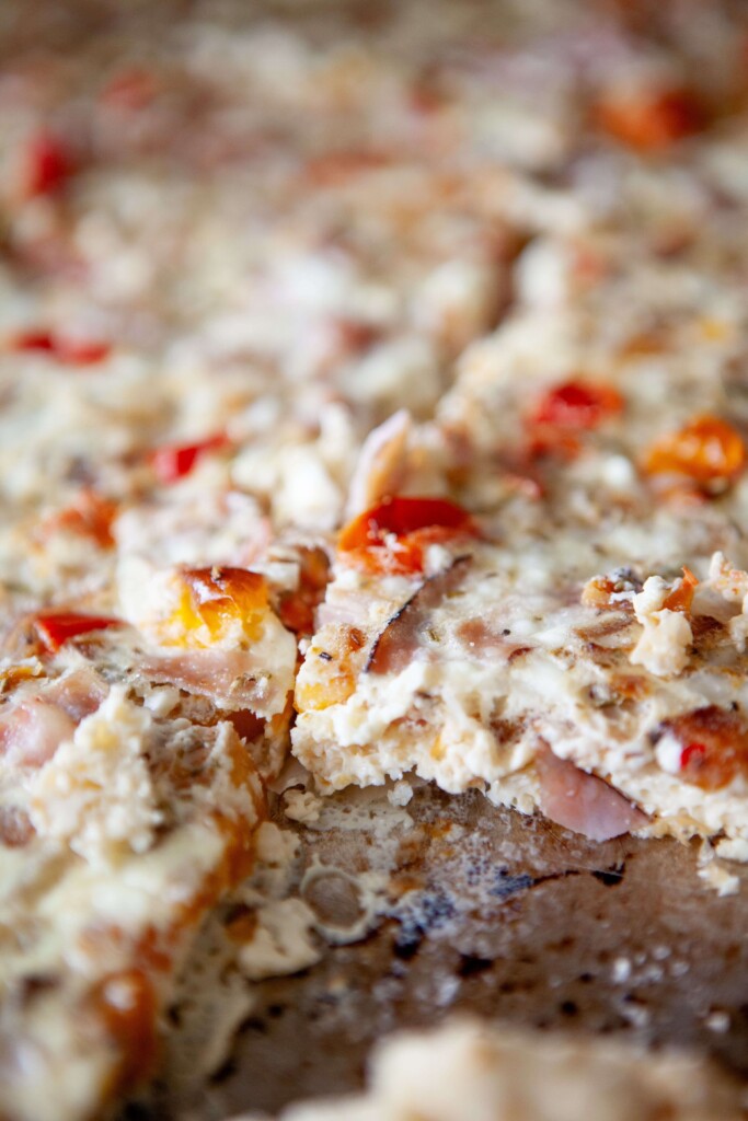 Upclose photo of slice of roasted veggie egg bake.