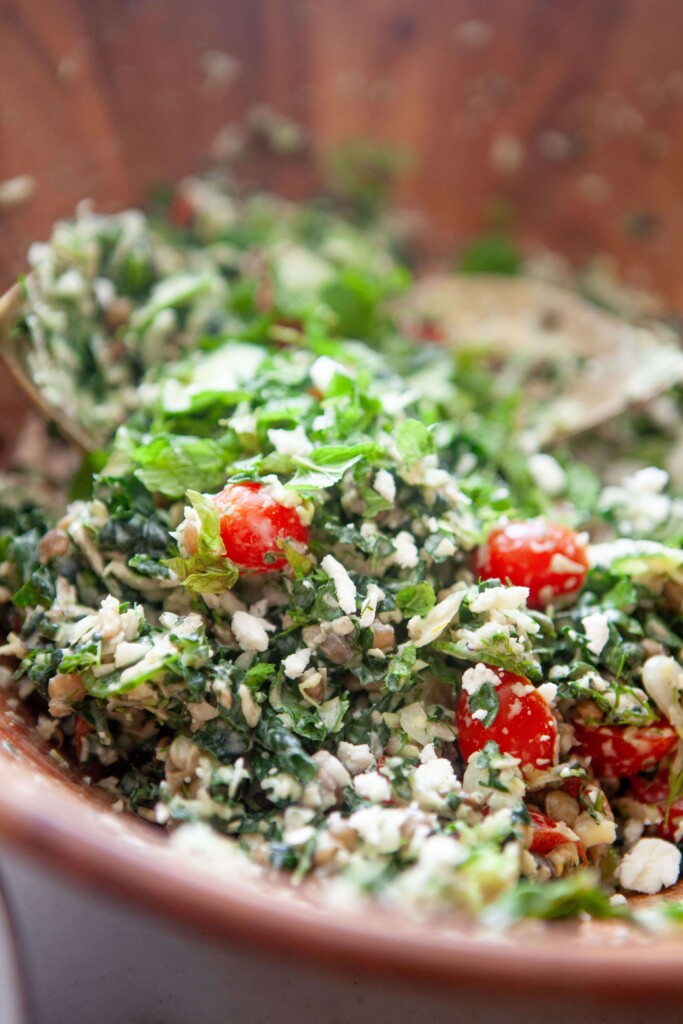 Greek chopped kale salad in bowl mixed together.
