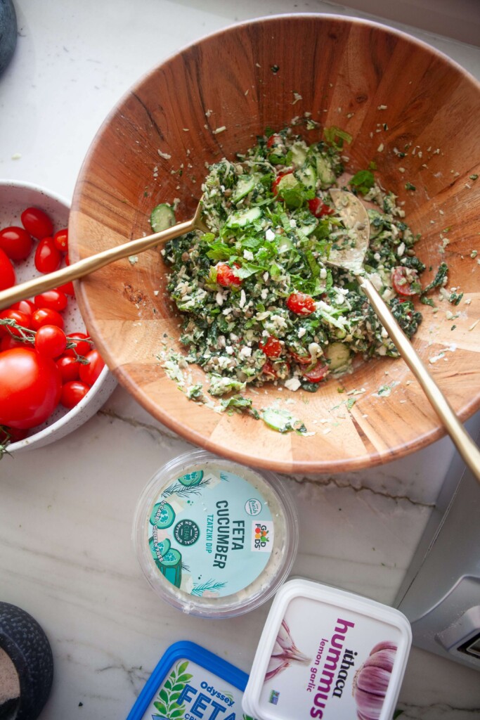 Greek chopped kale and lentil salad chopped and mixed together in a bowl.